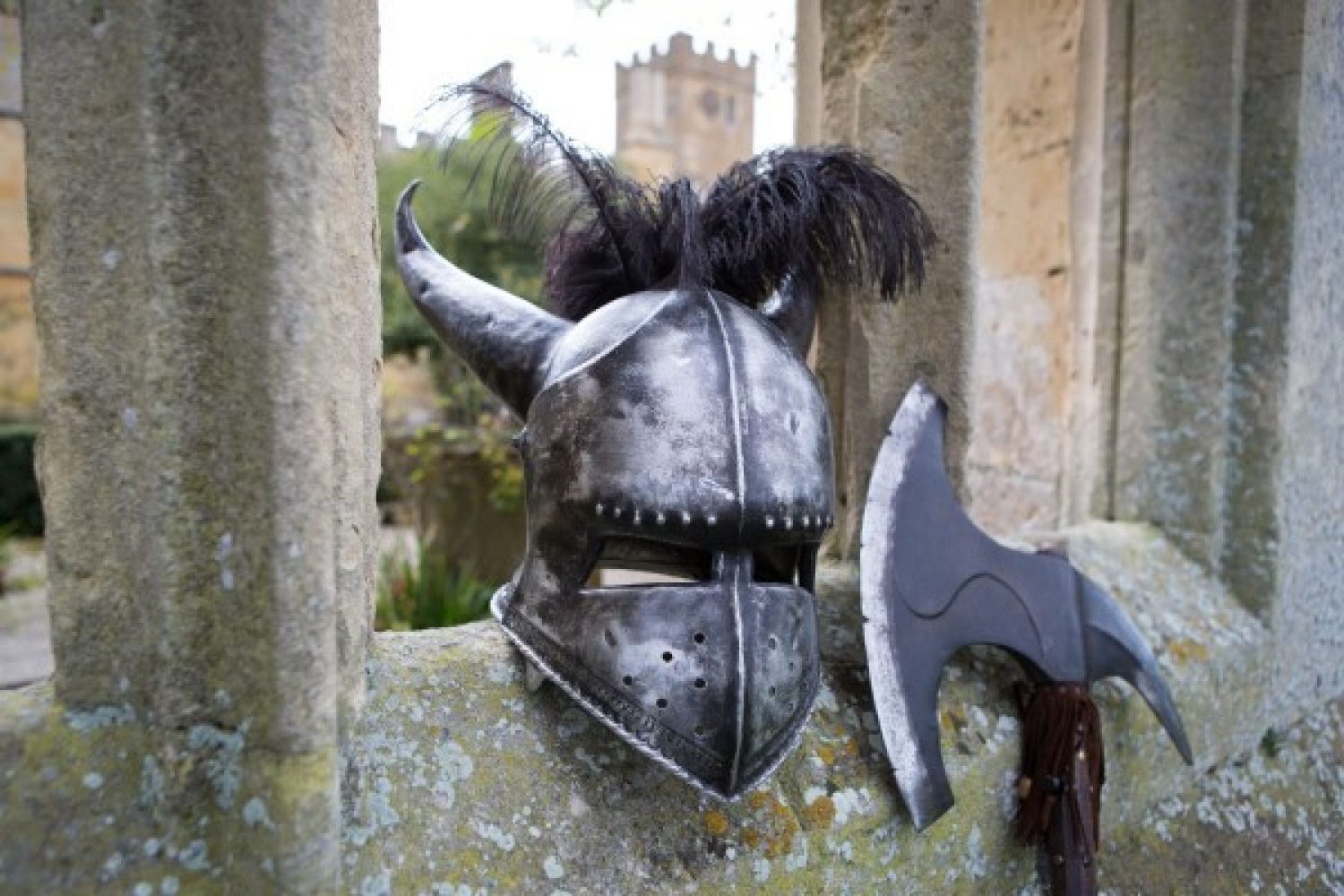 A medieval helmet and axe sit perched on a wall