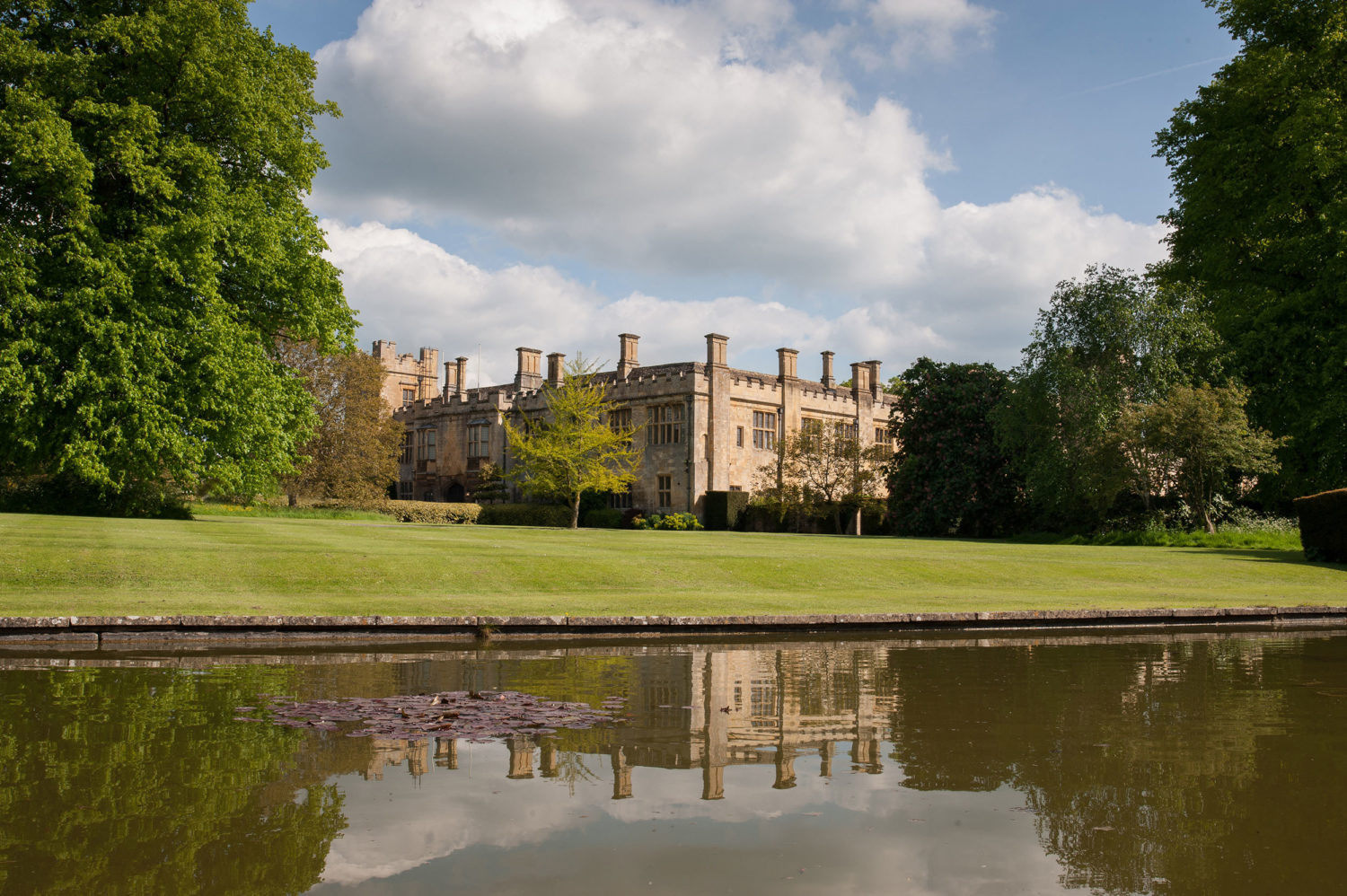 Exterior view of the castle from across a lake