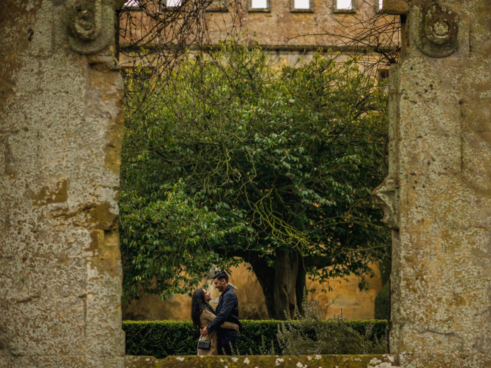 Couple seen kissing through ruins