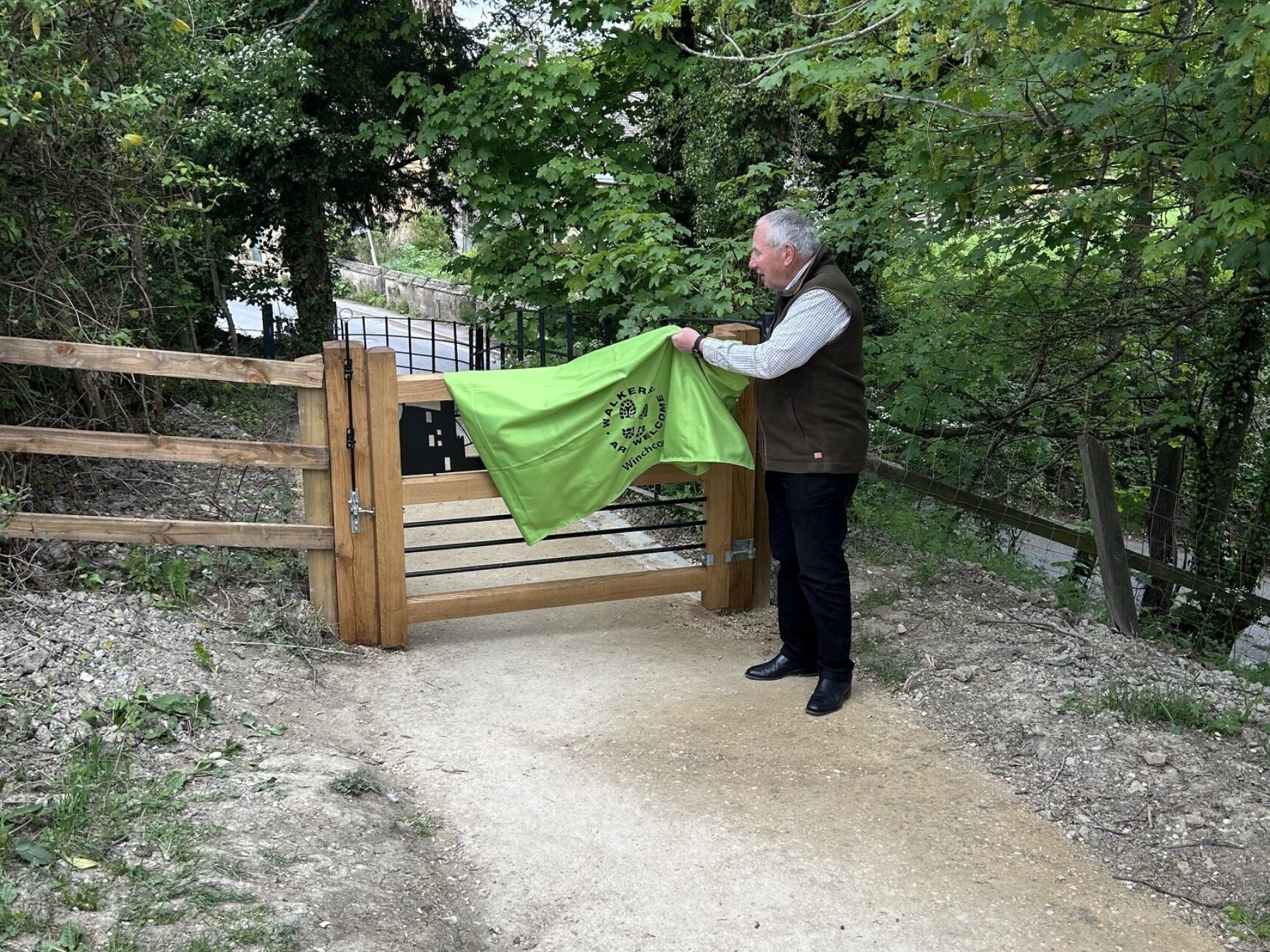 Town Councillor Jim Mason unveils the footpath gate