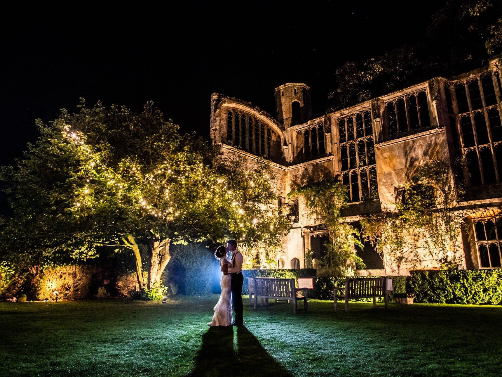 Bride and Groom silhouette's in front of back-lit ruins